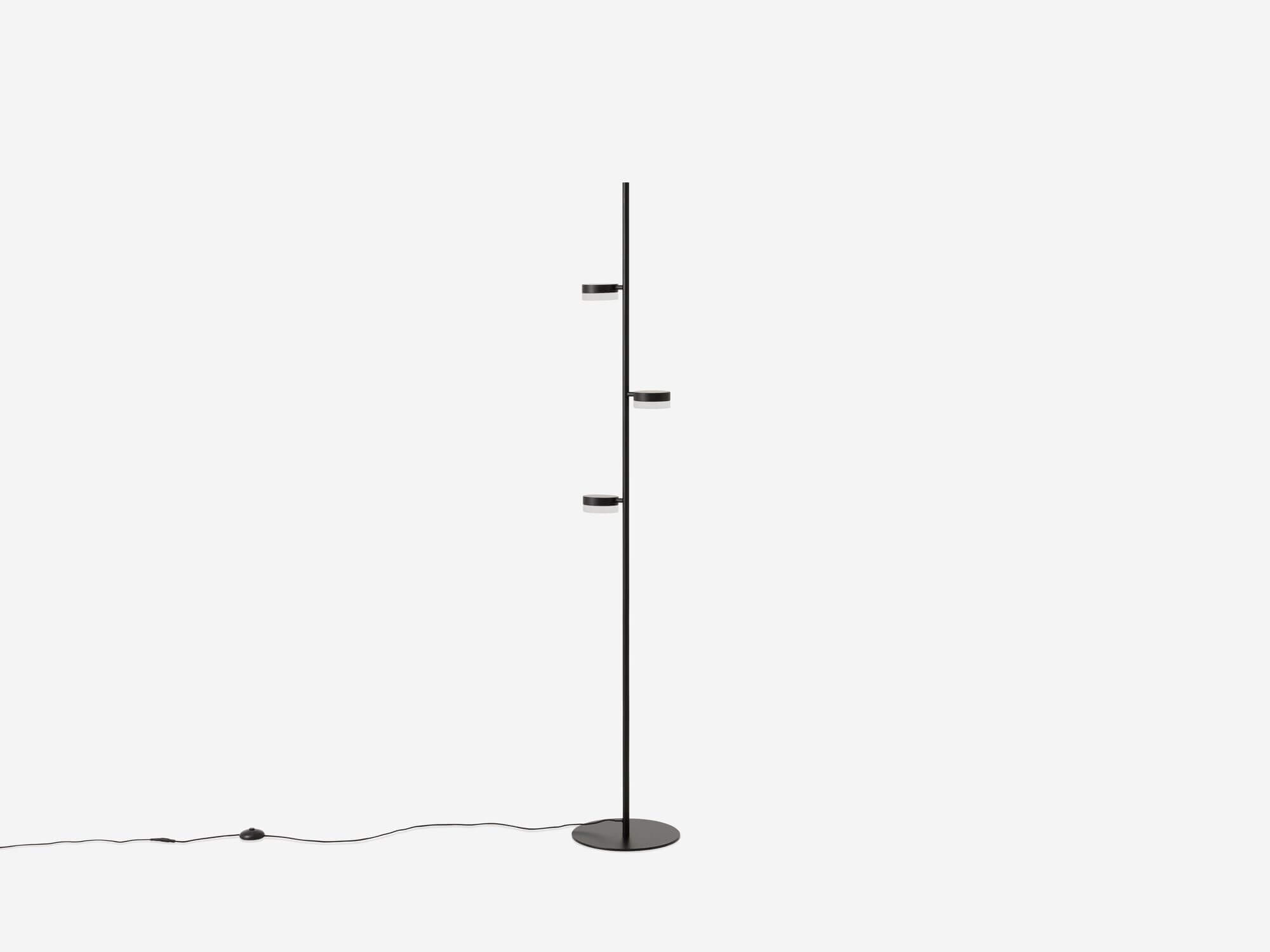 The Row living room floor lamp in a white room